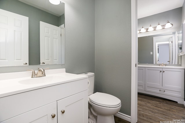 bathroom featuring vanity, hardwood / wood-style flooring, and toilet