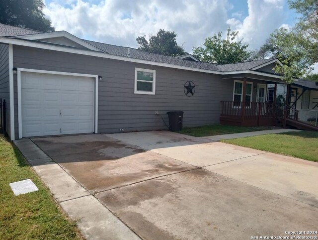 exterior space featuring a garage and a lawn