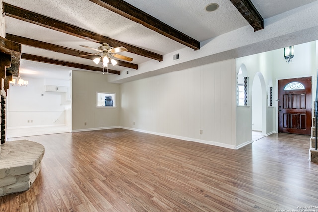 living room featuring beam ceiling, a textured ceiling, hardwood / wood-style flooring, and ceiling fan with notable chandelier