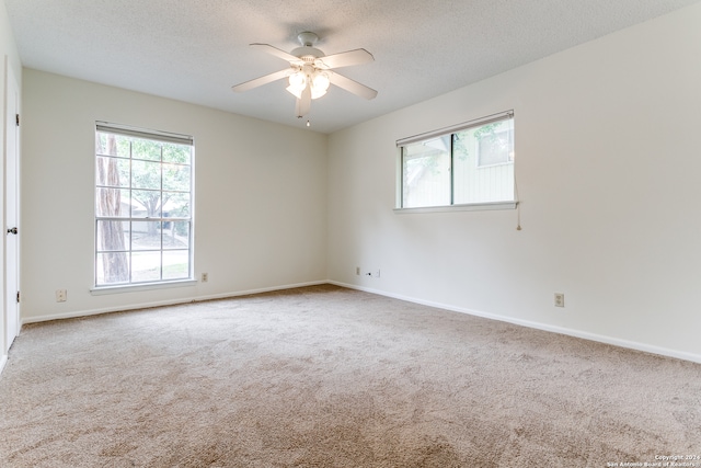 carpeted empty room featuring a textured ceiling and ceiling fan