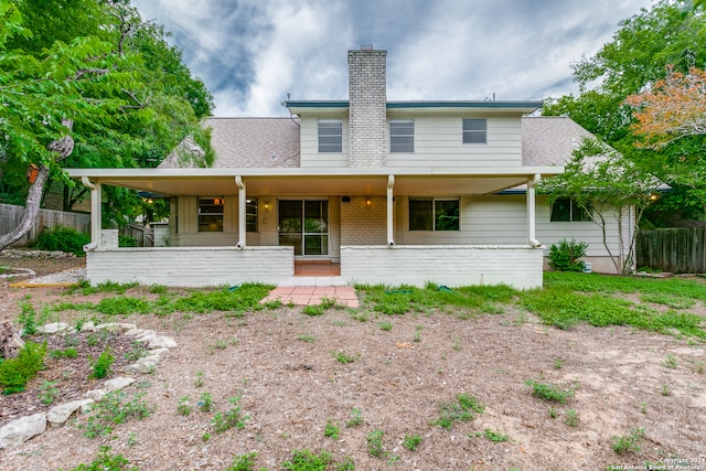 back of property with covered porch