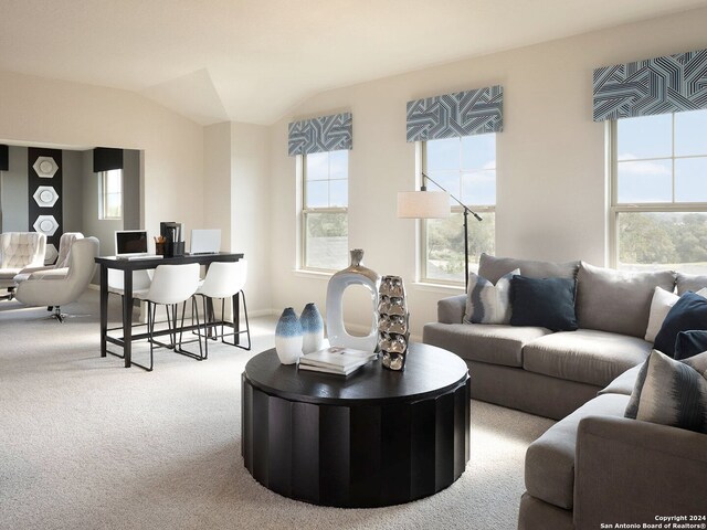 living room featuring vaulted ceiling, light colored carpet, and plenty of natural light