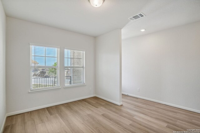 spare room featuring light wood-type flooring