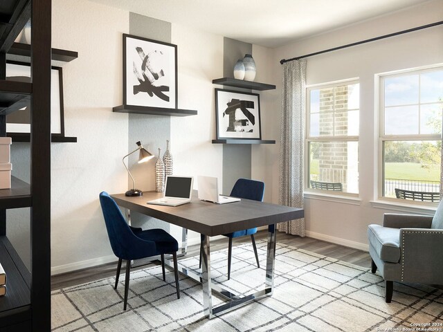 home office with light hardwood / wood-style flooring