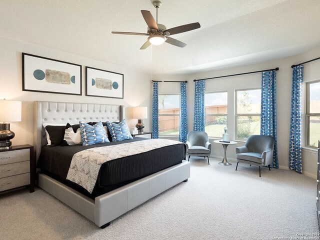 bedroom featuring a textured ceiling, ceiling fan, and carpet floors