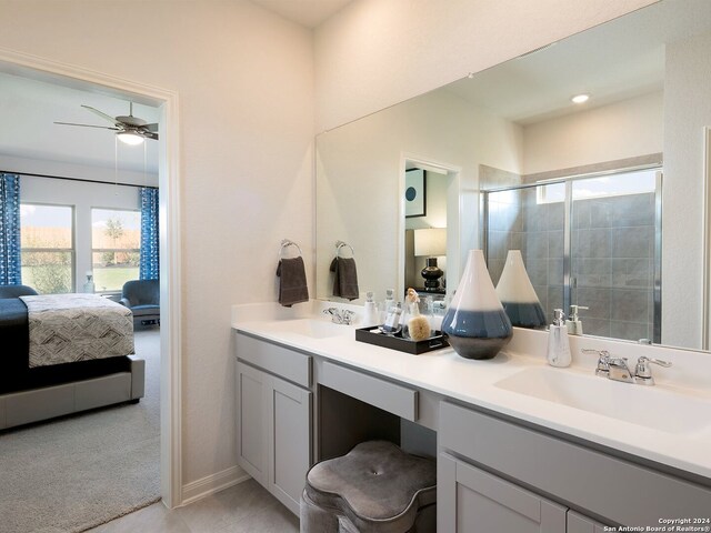 bathroom featuring walk in shower, ceiling fan, and vanity