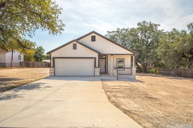 view of front of home featuring a garage and a porch