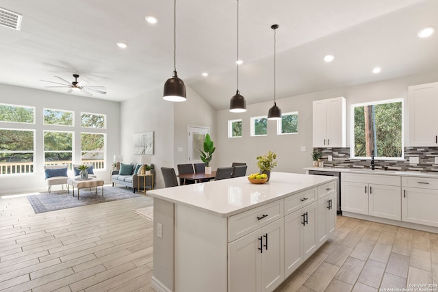 kitchen with white cabinetry, ceiling fan, plenty of natural light, and decorative light fixtures