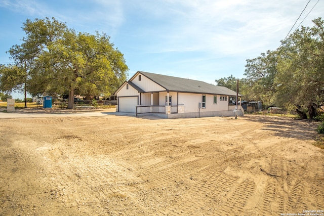 rear view of house with a garage