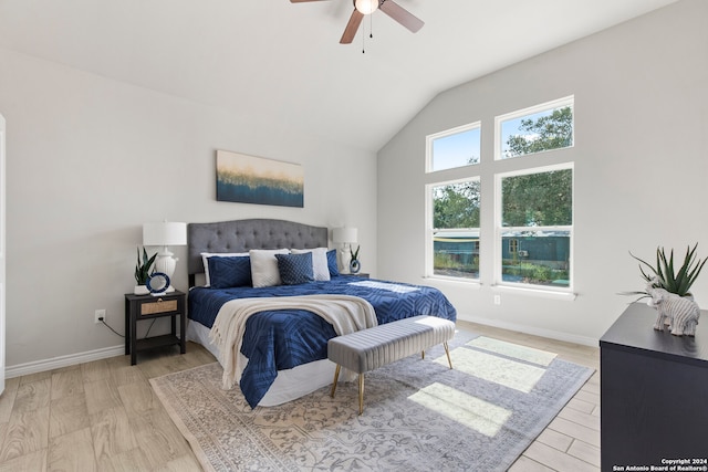 bedroom featuring light hardwood / wood-style flooring, vaulted ceiling, and ceiling fan