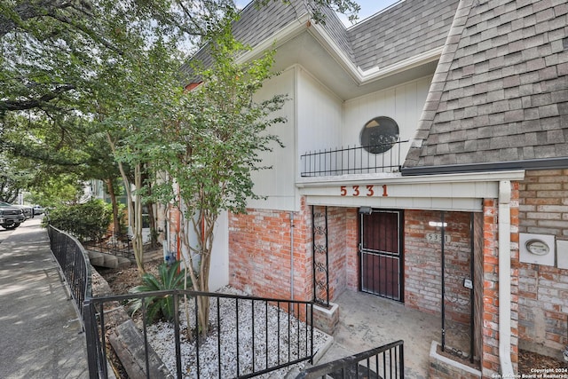 view of exterior entry featuring a balcony