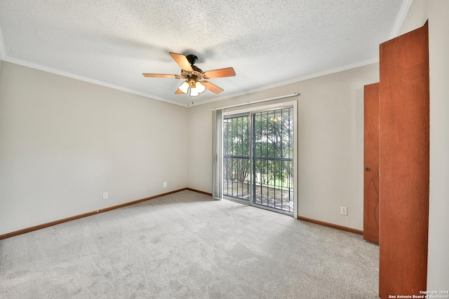 spare room featuring crown molding, light carpet, ceiling fan, and a textured ceiling