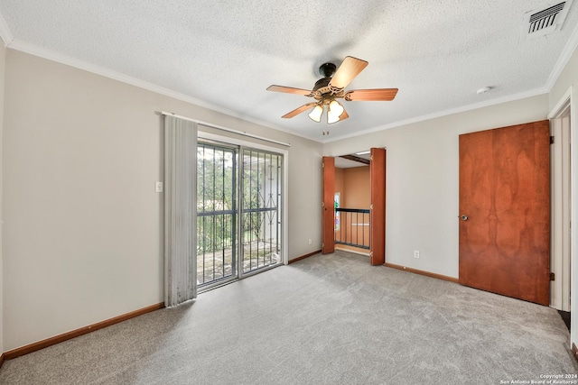 spare room with crown molding, light colored carpet, ceiling fan, and a textured ceiling