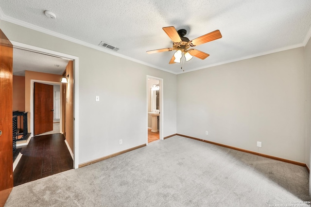 unfurnished bedroom with crown molding, carpet floors, and a textured ceiling