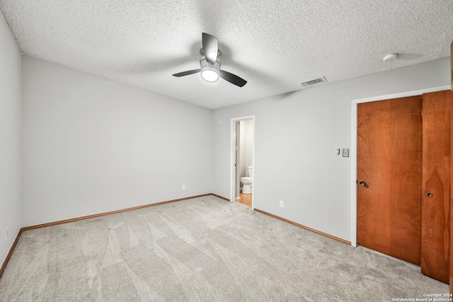 carpeted empty room featuring a textured ceiling and ceiling fan