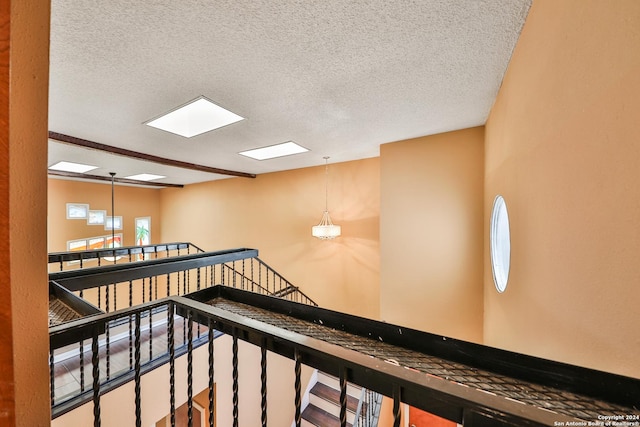 corridor featuring a textured ceiling