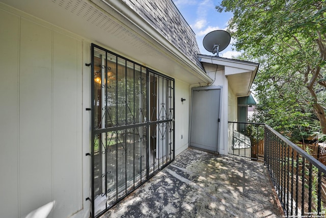 view of exterior entry with a balcony