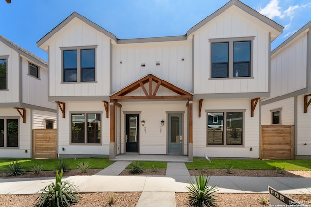 modern farmhouse style home featuring covered porch