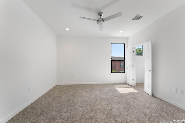 empty room featuring carpet floors and ceiling fan