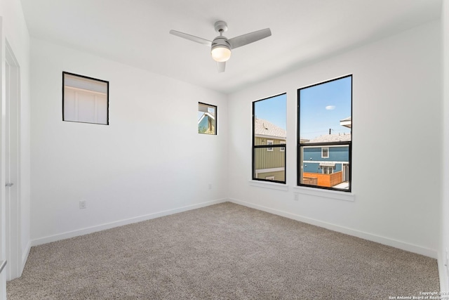 carpeted empty room featuring ceiling fan