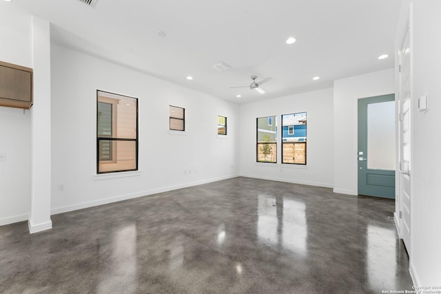 spare room featuring finished concrete flooring, baseboards, a ceiling fan, and recessed lighting