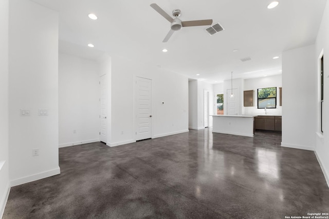 unfurnished living room featuring ceiling fan