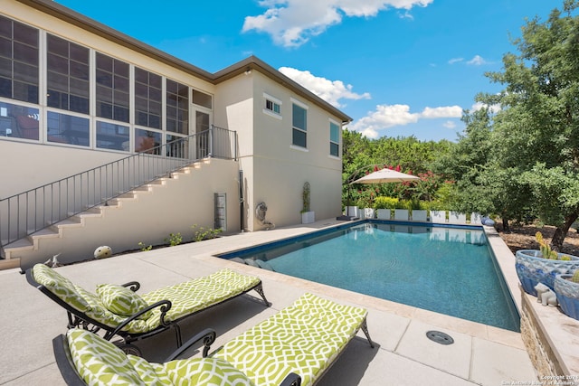 view of swimming pool with a patio