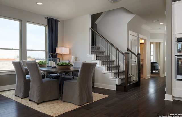 dining area featuring ornamental molding and hardwood / wood-style floors