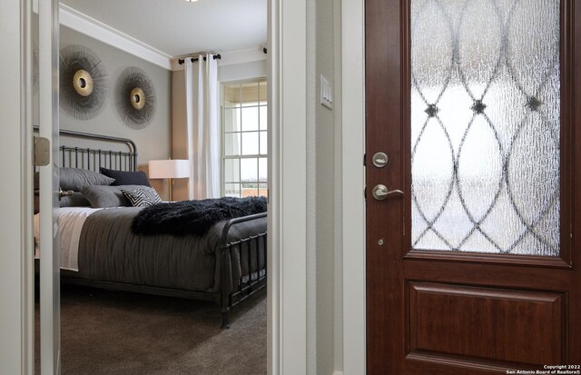 carpeted bedroom featuring ornamental molding