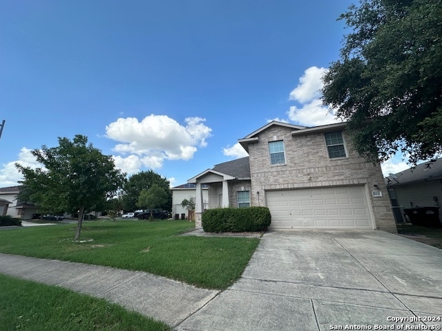 view of front of house featuring a garage and a front lawn