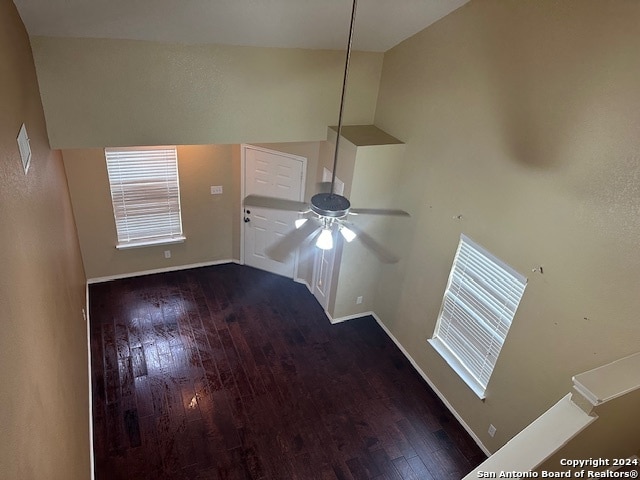 unfurnished living room featuring a high ceiling, ceiling fan, and hardwood / wood-style floors