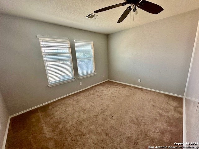 empty room with carpet flooring and ceiling fan