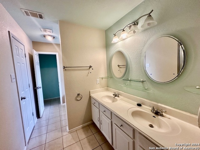 bathroom featuring tile patterned floors and dual bowl vanity