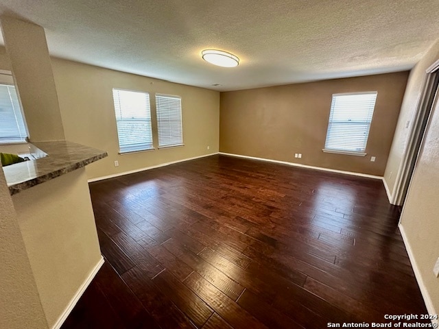 interior space featuring dark hardwood / wood-style flooring and a textured ceiling