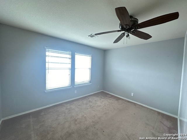 spare room featuring carpet floors and ceiling fan