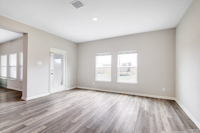 unfurnished room with hardwood / wood-style floors