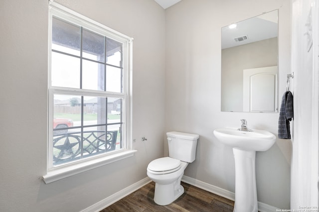 bathroom featuring wood-type flooring and toilet