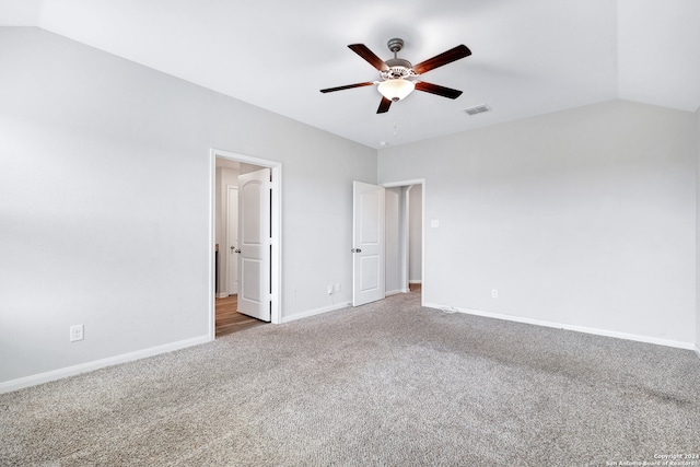 unfurnished bedroom featuring lofted ceiling, carpet floors, and ceiling fan