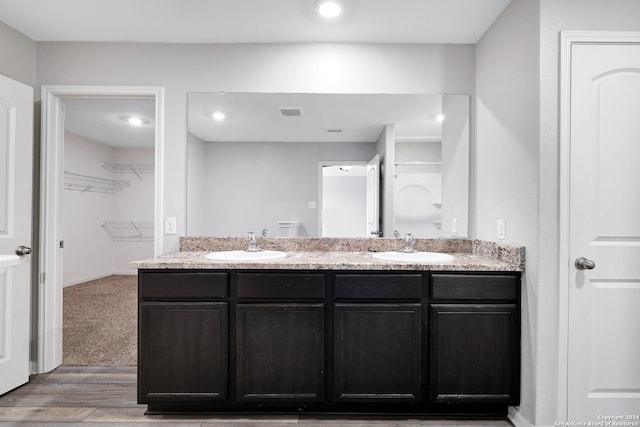 bathroom featuring hardwood / wood-style floors and double vanity