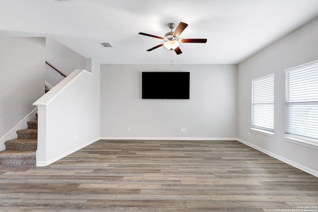 empty room with light wood-type flooring and ceiling fan