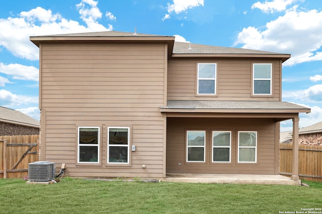 back of property featuring central air condition unit, a patio area, and a yard