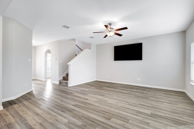 unfurnished living room with light hardwood / wood-style flooring and ceiling fan