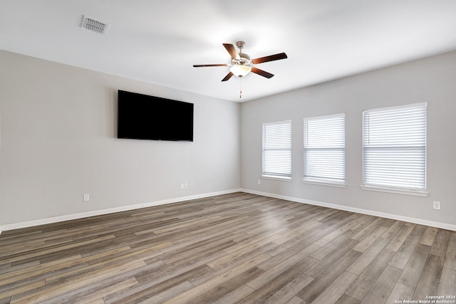 spare room featuring hardwood / wood-style floors and ceiling fan