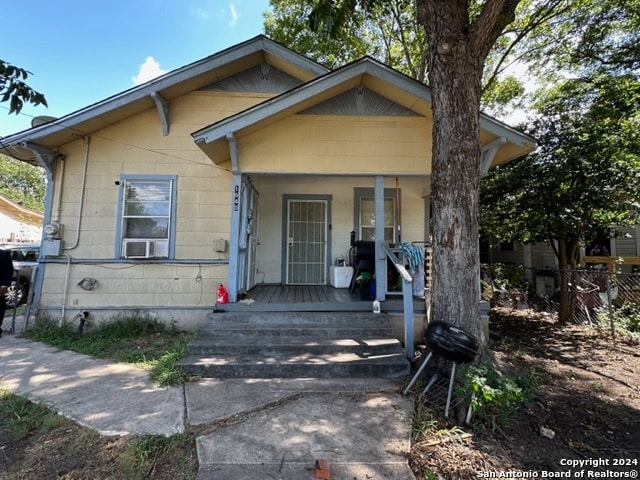 bungalow-style house with cooling unit and covered porch