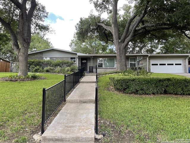 ranch-style home featuring a garage and a front yard