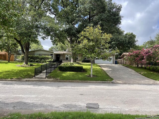 ranch-style house with a garage and a front yard