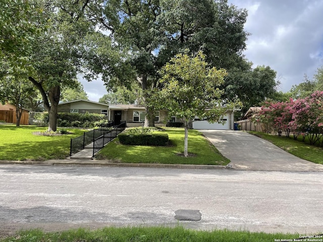 view of front of house featuring a garage and a front lawn