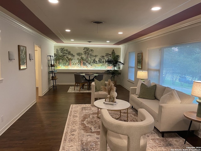 living room with dark hardwood / wood-style flooring, crown molding, and plenty of natural light