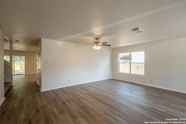 unfurnished room with dark hardwood / wood-style flooring, ceiling fan, and a textured ceiling