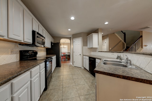 kitchen with sink, white cabinetry, tasteful backsplash, and black appliances